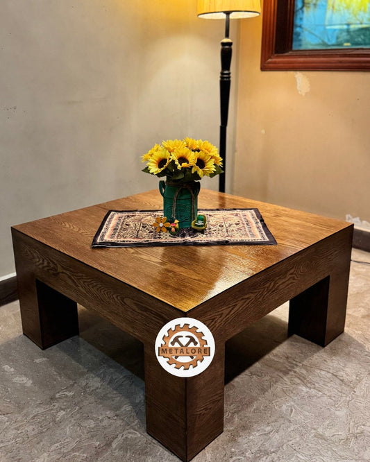 Rustic square wood coffee table with block legs in living room corner