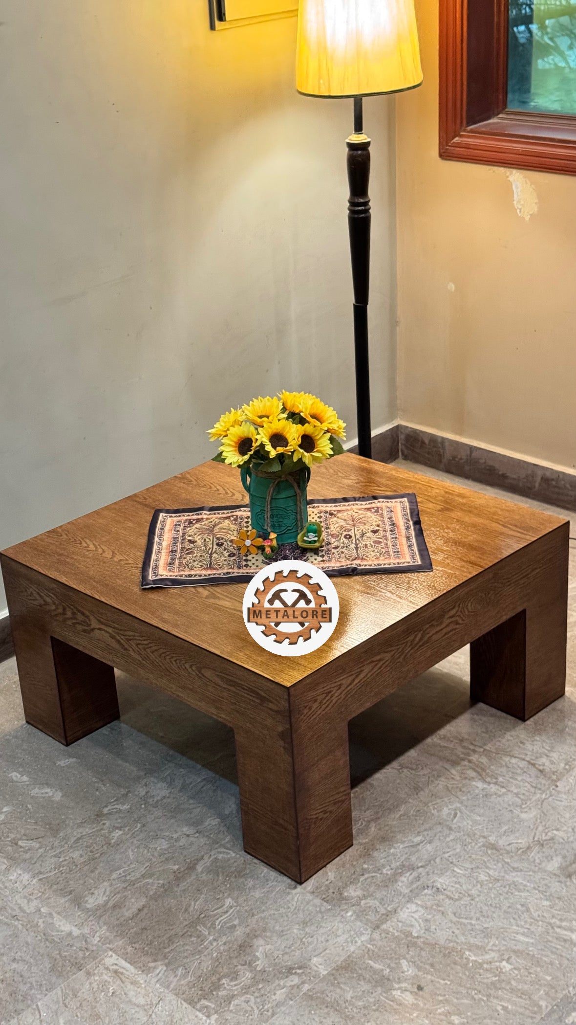 Close-up of wood grain coffee table with sunflower vase centerpiece